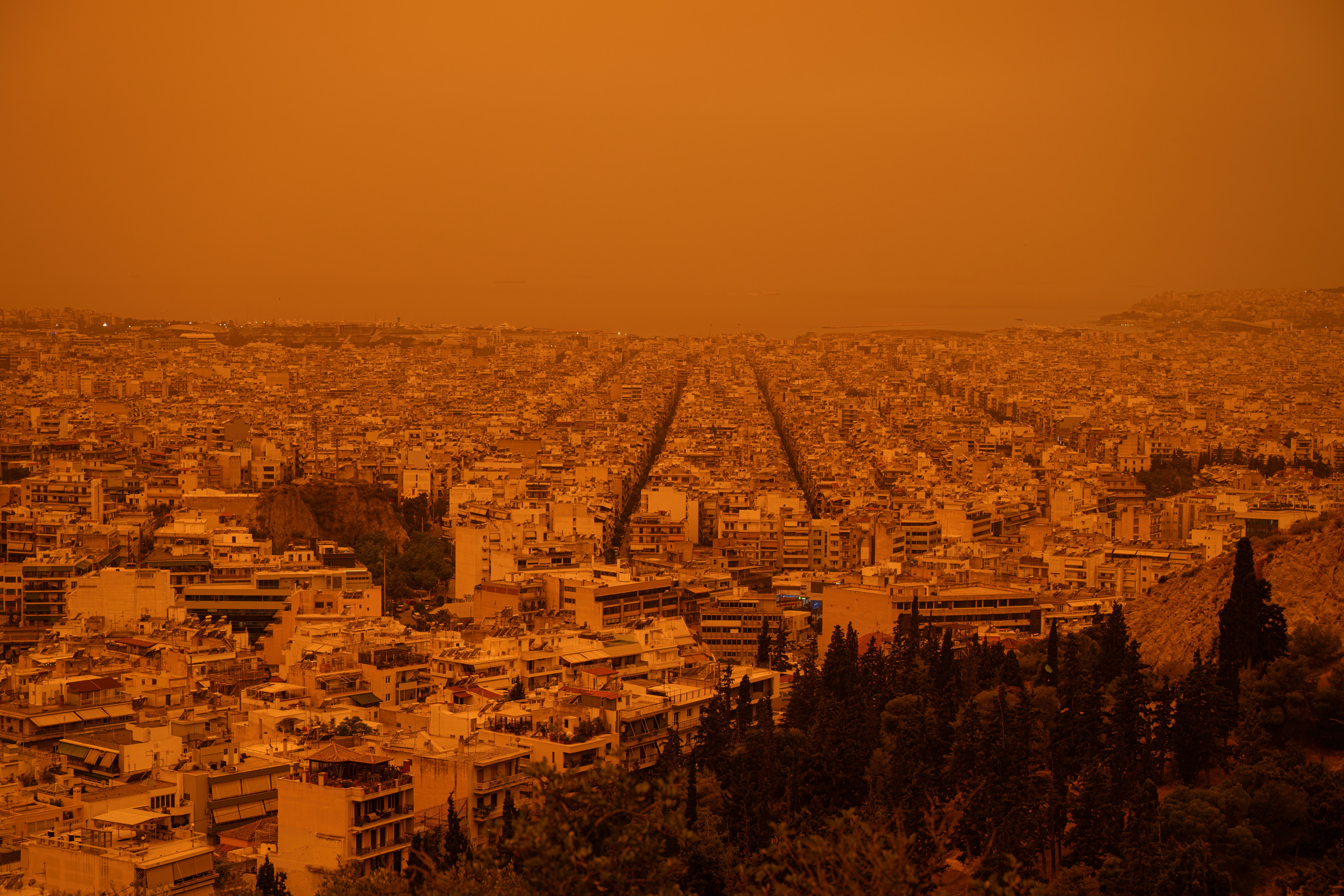 Athens cityscape beneath an orange sky, 2024