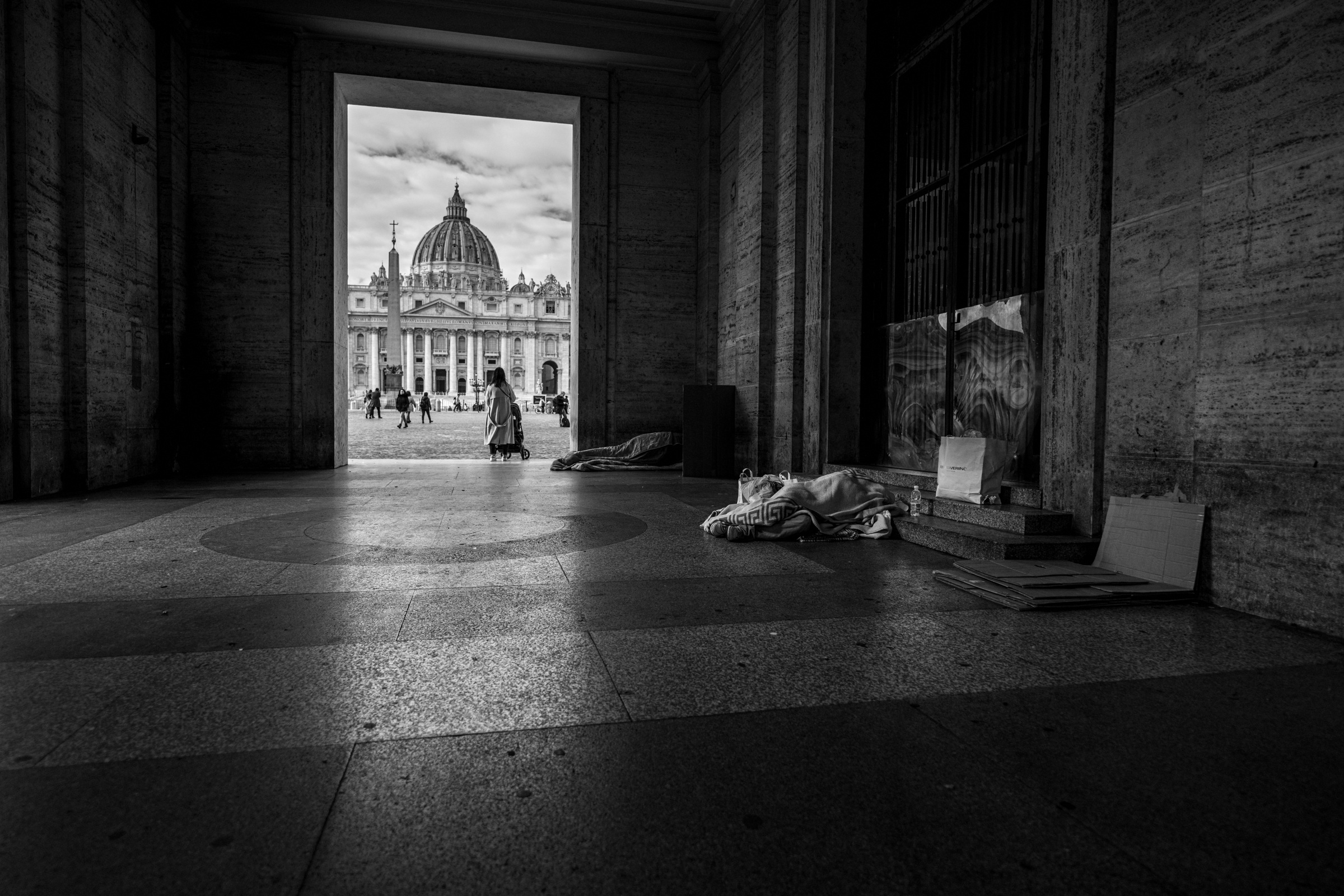 View of St Peter’s Basilica through a shaded passage, Rome, 2023